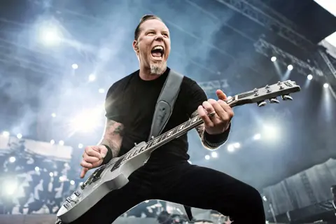 James Hetfield giovane, chitarrista dei Metallica, urla sul palco con la sua chitarra.